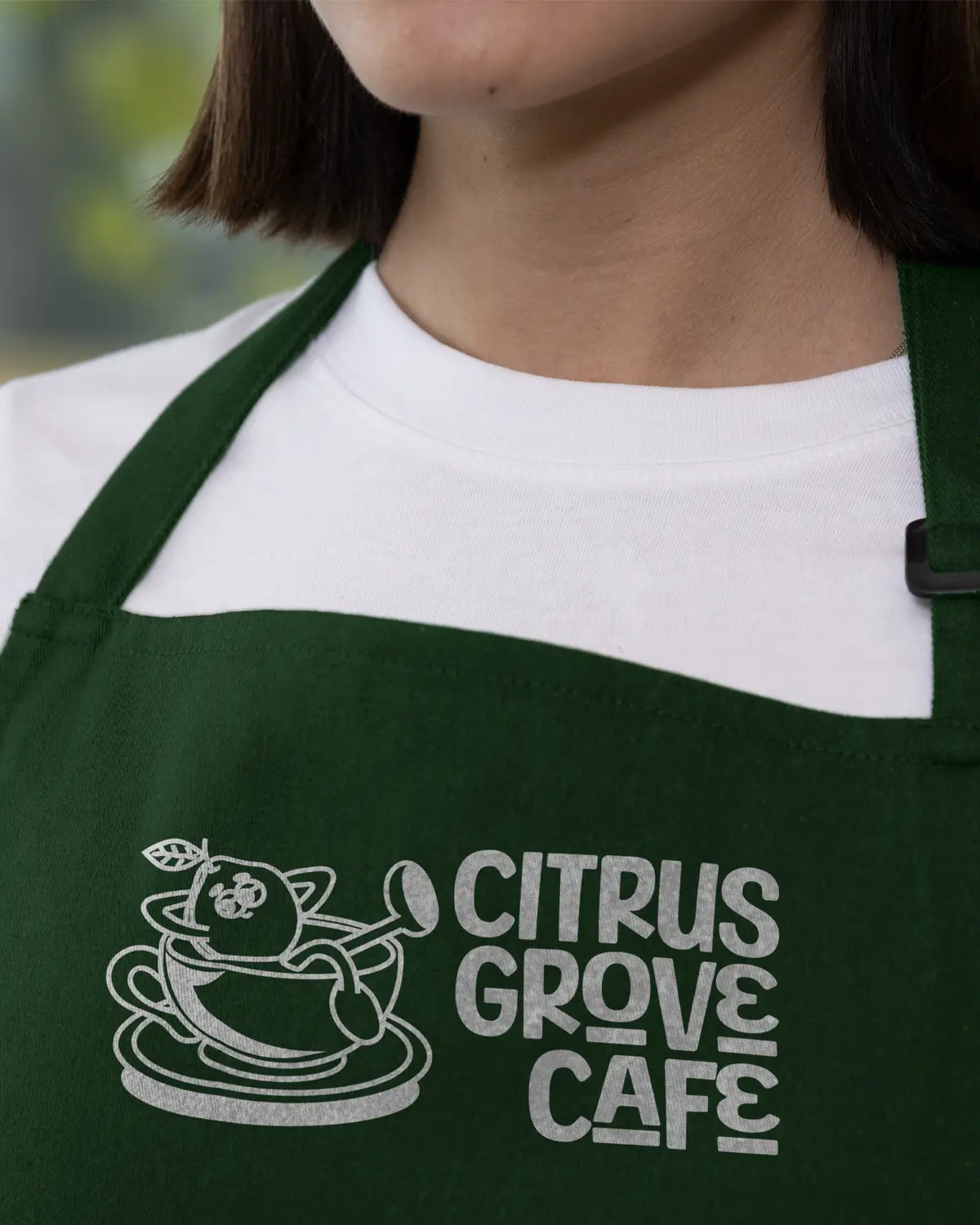 Citrus Grove Café branded apron on a waitress